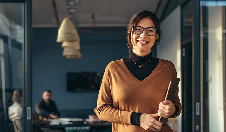 Caucasian Business Woman In Doorway Holding Binder